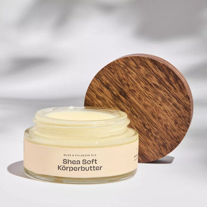 Geöffneter Glastiegel der Shea-Soft Bio Körperbutter, zeigt cremige, naturreine Textur für reichhaltige Pflege.